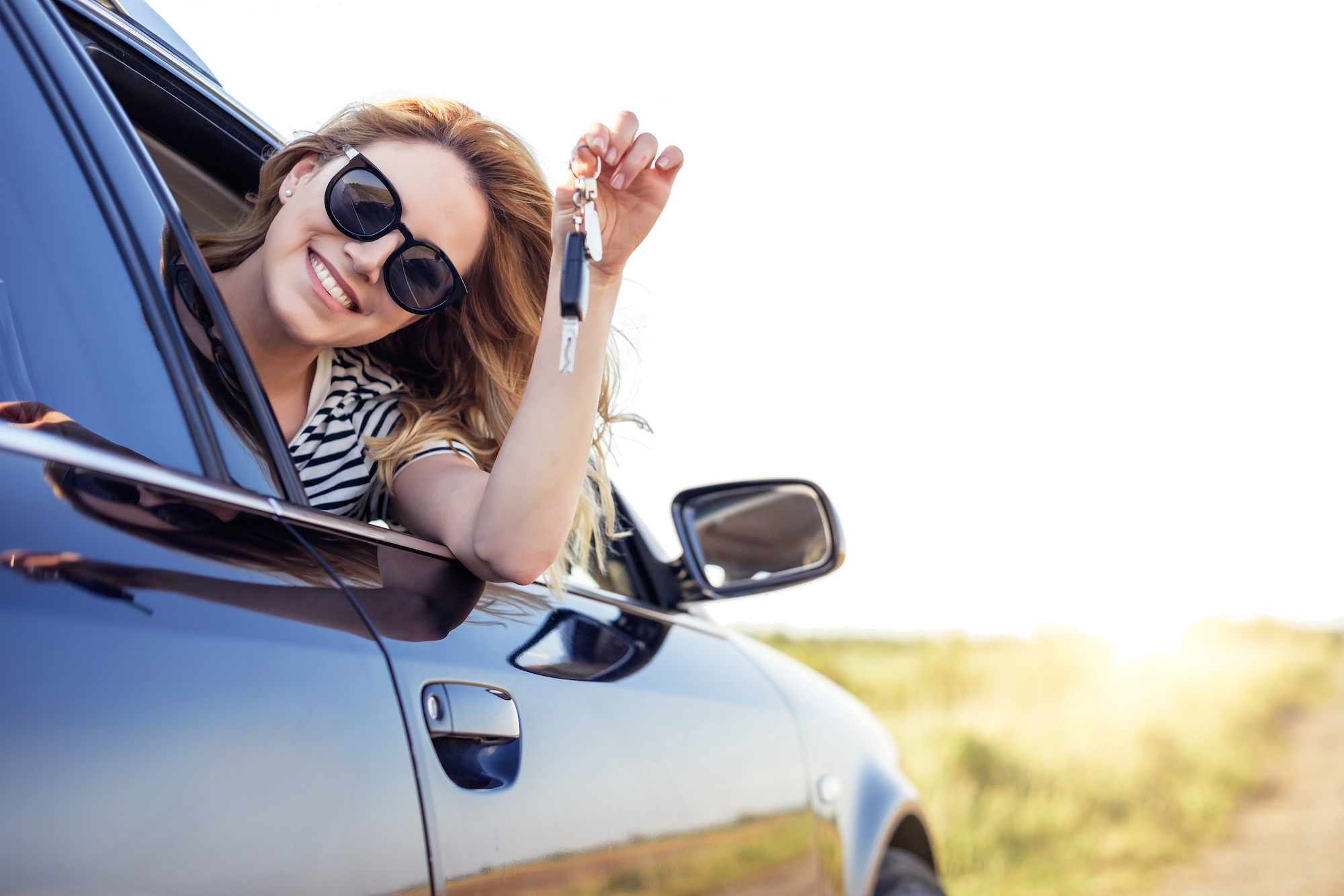 An,Attractive,Woman,In,A,Car,Holds,A,Car,Key